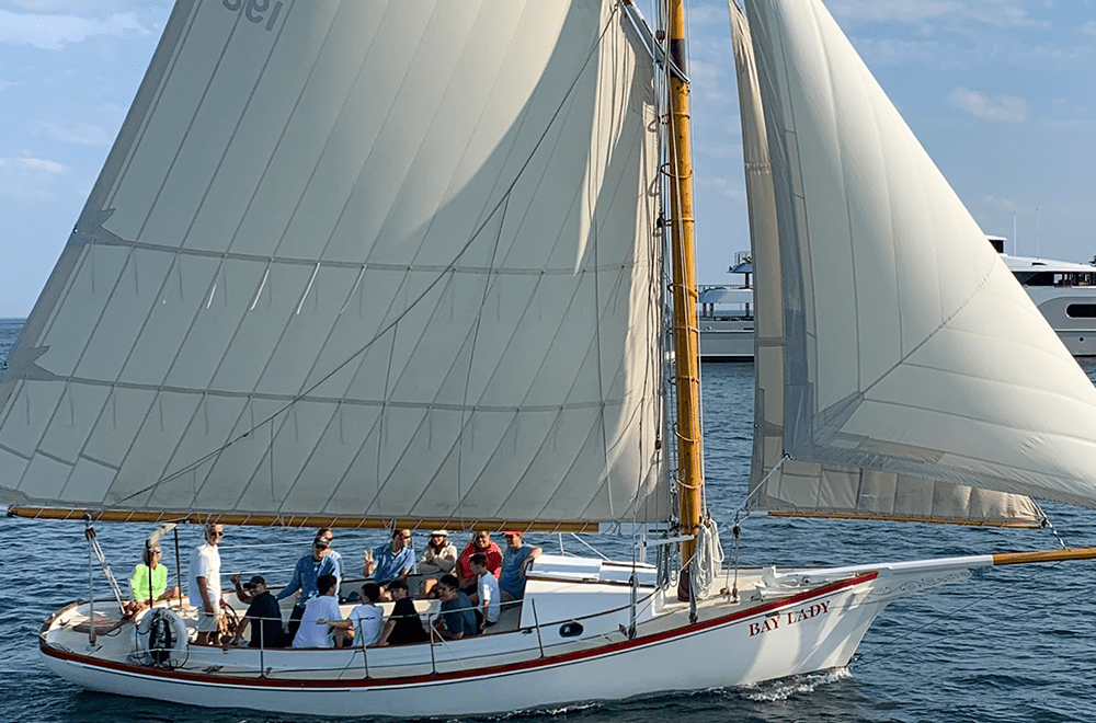Boothbay Harbor sailing trips passing rocky shoreline and spruce islands